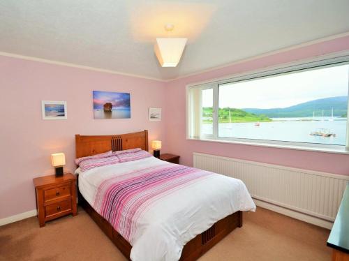 a bedroom with a bed and a large window at 2 Bed in Lochgilphead oc-ag692 in Tayvallich
