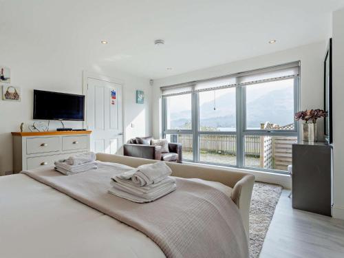 a bedroom with a large bed and a large window at 1 Bed in Crieff oc-58797 in Saint Fillans