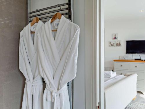 a bathroom with white towels hanging on a rack at 1 Bed in Crieff oc-58797 in Saint Fillans