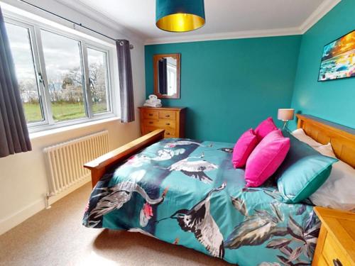 a bedroom with a bed with blue walls at 3 Bed in Onich oc-ca159 in Onich