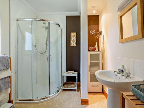 a bathroom with a glass shower and a sink at 1 Bed in Beauly oc-82779 in Beauly