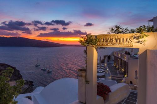 a building with a sign that reads banquet villas at sunset at Oia Mare Villas in Oia