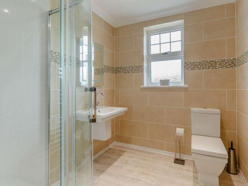 a bathroom with a shower and a toilet and a sink at 2 Bed in Fort William oc-83310 in Onich