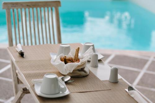 a table with a shell sitting on top at Oia Mare Villas in Oia