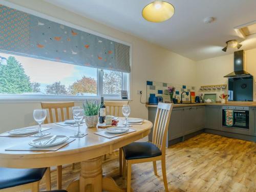 a dining room with a table and chairs and a kitchen at 3 Bed in Blairgowrie oc-90111 in Blairgowrie
