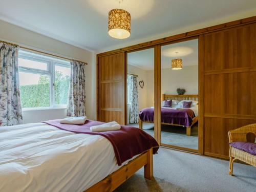 a bedroom with two beds and a mirror at 3 Bed in Blairgowrie oc-90111 in Blairgowrie