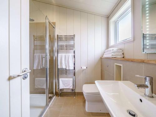 a bathroom with a toilet and a sink and a shower at 2 Bed in Wigton oc-80563 in Caldbeck