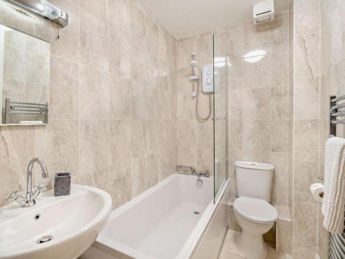 a bathroom with a tub and a toilet and a sink at 2 Bed in Ambleside oc-93287 in Near Sawrey