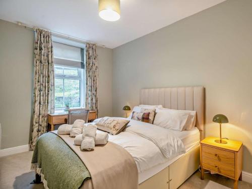 a bedroom with a large bed and a window at 2 Bed in Ambleside oc-93287 in Near Sawrey