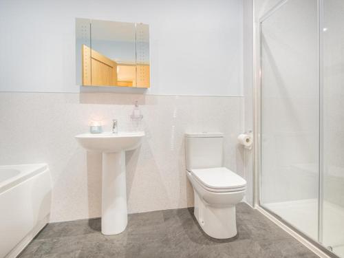 a bathroom with a toilet and a sink and a shower at 3 Bed in Keswick oc-sz217 in Threlkeld