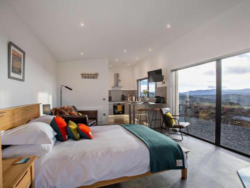 a bedroom with a bed and a large window at 1 Bed in Ardgay oc-90470 in Bonar Bridge