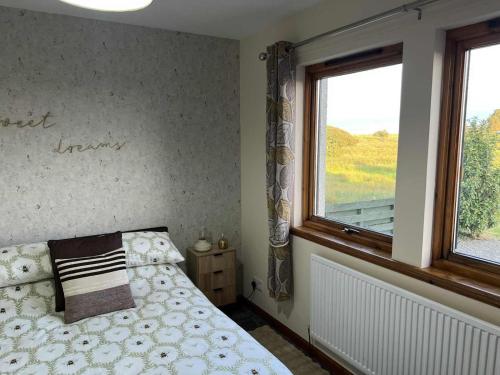 a bedroom with a bed and a window at 3 Bed in Newton Stewart oc-87541 in Mochrum