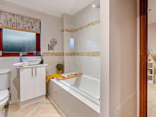 a bathroom with a tub and a sink and a toilet at 1 Bed in Dollar oc-95872 in Powmill