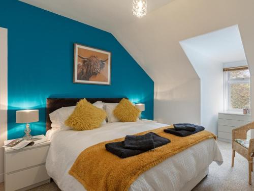 a bedroom with a large bed with a blue wall at 5 Bed in Melrose oc-79418 in Melrose