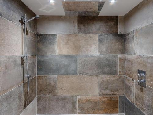 a bathroom with a shower with a stone wall at 5 Bed in Anstruther oc-83504 in Pittenweem