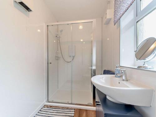a white bathroom with a shower and a sink at 2 Bed in Maybole oc-96012 in Maybole