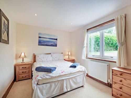 a bedroom with a bed with two night stands and a window at 1 Bed in Castle Douglas oc-ca371 in Castle Douglas