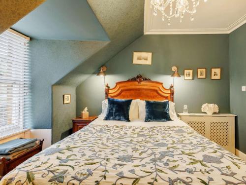 a bedroom with a large bed with a wooden headboard at 5 Bed in Dunkeld oc-90844 in Birnam