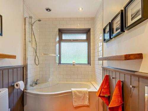 a bathroom with a tub and a window at 3 Bed in Pitlochry oc-ca207 in Struan