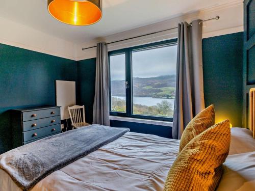 a bedroom with a bed and a large window at 3 Bed in Pitlochry oc-ca207 in Struan