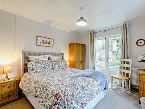 a bedroom with a large bed and a window at 1 Bed in Maybole oc-93562 in Maybole