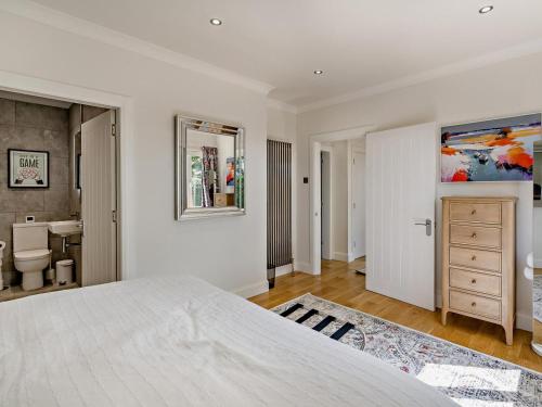 a white bedroom with a bed and a bathroom at 3 Bed in Anstruther oc-96111 in Pittenweem