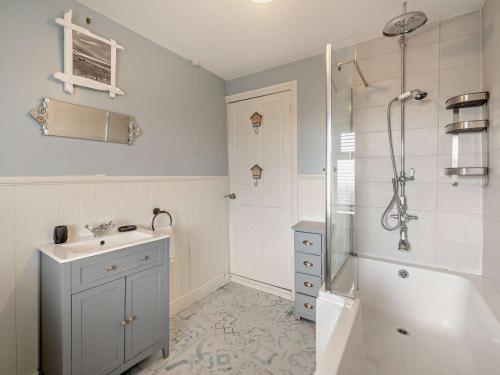a bathroom with a shower and a sink and a tub at 2 Bed in Millom oc-93608 in Millom