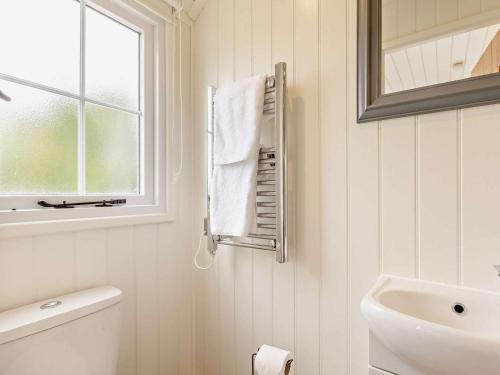 a bathroom with a sink and a toilet and a mirror at 1 Bed in Forfar oc-92331 in Kingsmuir