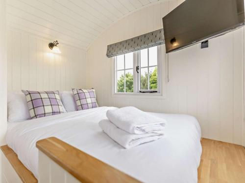 a white bed in a room with a window at 1 Bed in Forfar oc-92331 in Kingsmuir