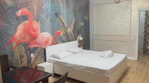 a bedroom with a bed and a mural of flamingos at INFINITY Hotel&Spa in Almaty