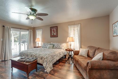 a bedroom with a bed and a couch at Sweeping Views! Charming Home Near Dtwn Jamestown in Jamestown