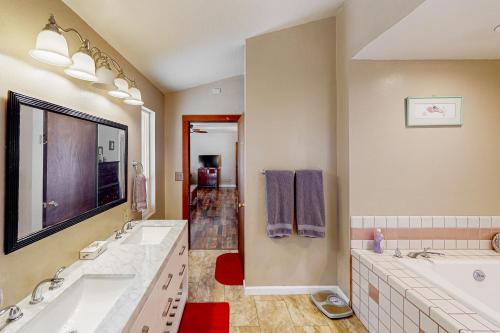a large bathroom with two sinks and two mirrors at Sweeping Views! Charming Home Near Dtwn Jamestown in Jamestown