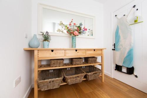 a console table with baskets and a vase with flowers at 2 Bed in Upper Vobster oc-c39495 in Mells