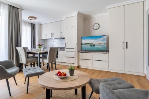 a living room with a table and a dining room at K & R Appartements Binz in Binz