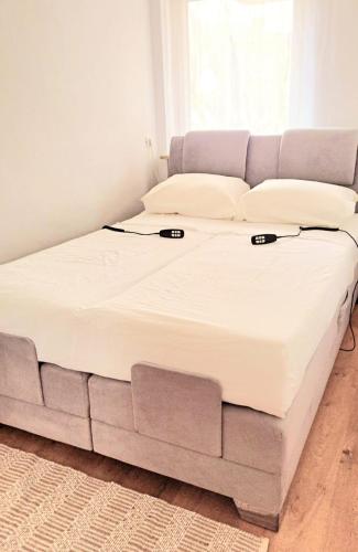 a large bed in a room with a couch at City Apartment Starnberg in Starnberg