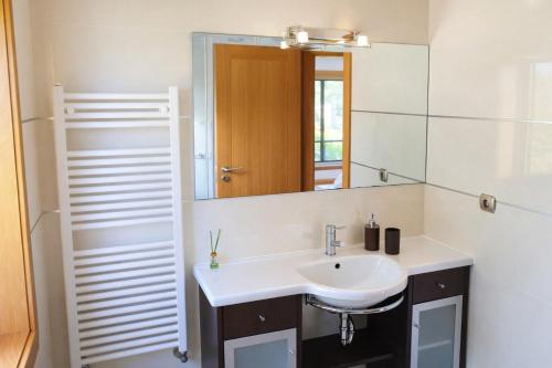 a bathroom with a sink and a mirror at Oporto Beach Apartment in Vila Nova de Gaia