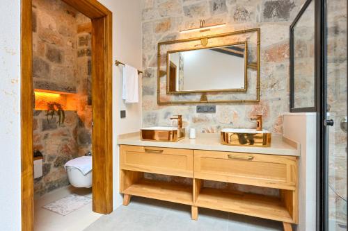 a bathroom with a sink and a mirror at Villa Skylight Göcek Fethiye in Fethiye