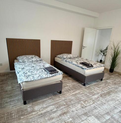 two twin beds in a room with at Modernes Apartment im Grünen in Kroppach