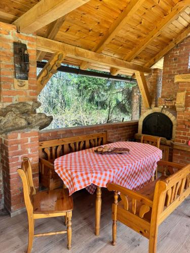 a dining room with a table and chairs and a window at Forest Escape Banja Luka in Banja Luka
