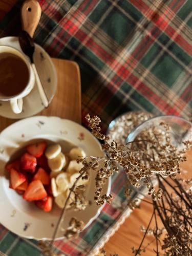 a bowl of fruit and a cup of coffee on a table at Casa Morosina in Svetvinčenat