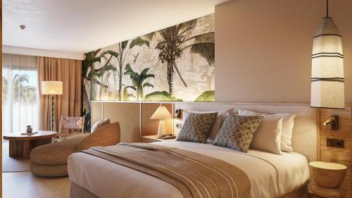a bedroom with a large bed and a living room at HD Sensarena - Adults Only in Costa Teguise