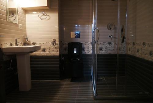 a bathroom with a shower and a sink at Serenity stay in Kathmandu
