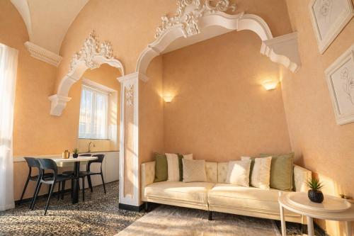 a living room with a couch and a table at Old Town Bonbonniere in Bordighera