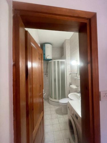 a bathroom with a sink and a washing machine at Hideout apartments Travnik in Travnik