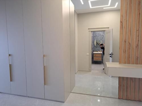 a person taking a picture of a room with a mirror at Sea Breeze Nardaran open kitchen apartment in Nardaran