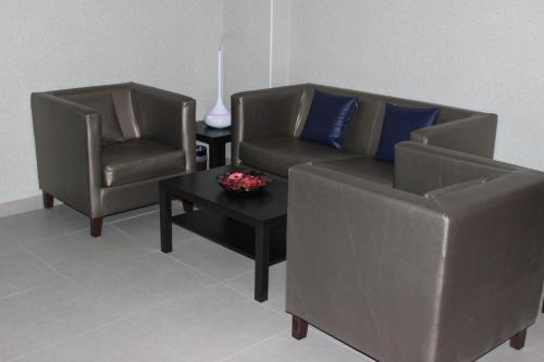 a living room with two chairs and a couch and a table at Executives Hotel - Olaya in Riyadh