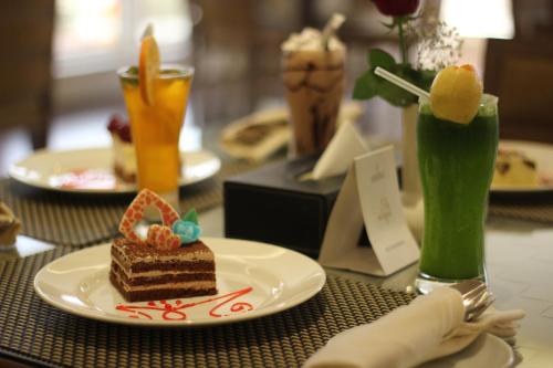 a piece of cake on a plate on a table at Executives Hotel - Olaya in Riyadh