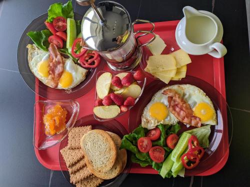 a tray of breakfast food with eggs cheese and fruit at Apartments in Chakvi in Chakvi