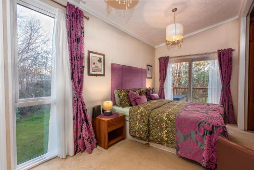 a bedroom with a bed and a window at Rivendale Lodge in Port Seton