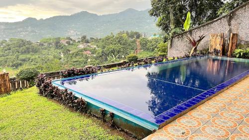 a large swimming pool sitting next to a building at Villa Kay Height in Kopo 2